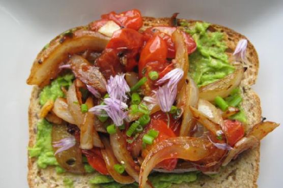 Avocado toast with caramelized onion and grape tomatoes