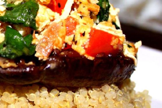 Vegan stuffed portobello mushroom over quinoa